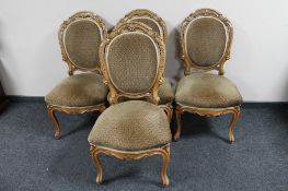 A set of four carved French walnut dining chairs
