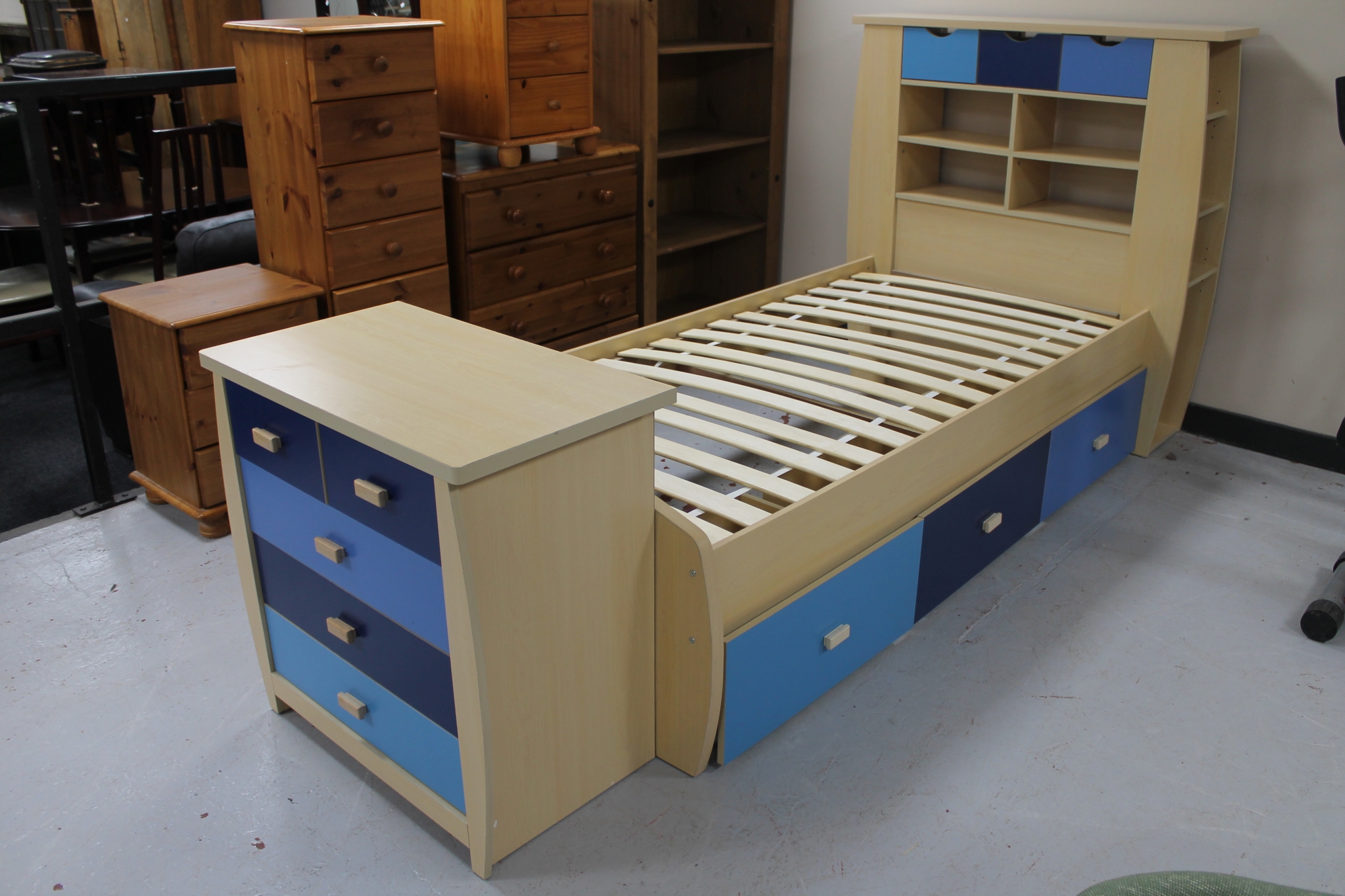 A child's 3' bed frame with head fitted drawers and shelves,