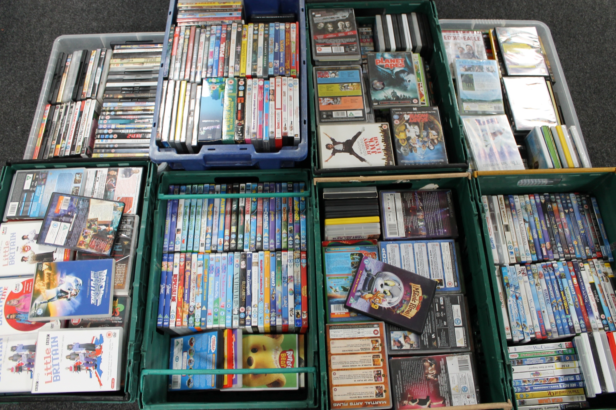 Eight plastic crates of DVD's