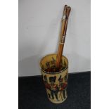 A 20th century stick stand depicting figures in military dress and four swagger sticks one with