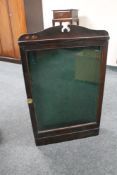 An early 20th century pine glazed door notice cabinet