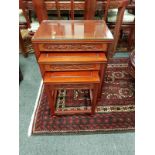 A Chinese carved hardwood nest of three tables,