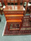A Chinese carved hardwood nest of three tables,