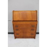 A mid century teak bureau