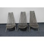 A set of three teak folding garden chairs