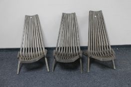 A set of three teak folding garden chairs