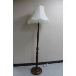 A beech standard lamp with shade