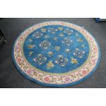 A circular floral Chinese rug on blue ground. CONDITION REPORT: 182cm diameter.