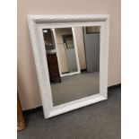 A painted white traditional style mirror,