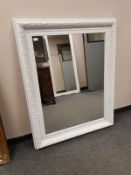 A painted white traditional style mirror,