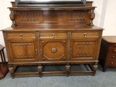 An early 20th century carved oak buffet backed sideboard,