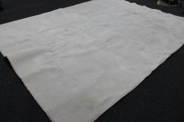 A large cream woolen carpet