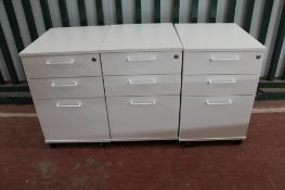 Three white three drawer under-desk filing chests