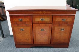 A contemporary inlaid mahogany effect triple door sideboard