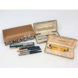 A Parker Duofold fountain pen with 14ct gold nib, matching pencil, another Parker pen with gold nib,