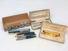 A Parker Duofold fountain pen with 14ct gold nib, matching pencil, another Parker pen with gold nib,