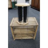 A wicker two tier stand together with a revolving CD stand