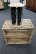 A wicker two tier stand together with a revolving CD stand