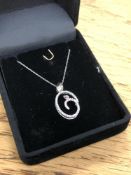 A 10ct white gold diamond set pendant on chain