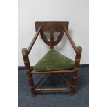 A carved triangular armchair