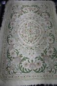 A chain stitch rug on cream ground