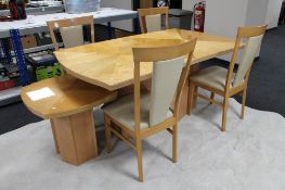 A contemporary pine effect high gloss pedestal dining table and four high backed chairs and