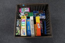 A storage box containing a quantity of assorted jigsaws and board games