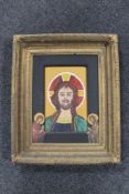 A 20th century religious icon style oil on board of Christ, in heavy gilt frame.