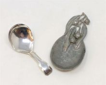 A Georgian silver caddy spoon and an Arts & Crafts pewter caddy spoon.