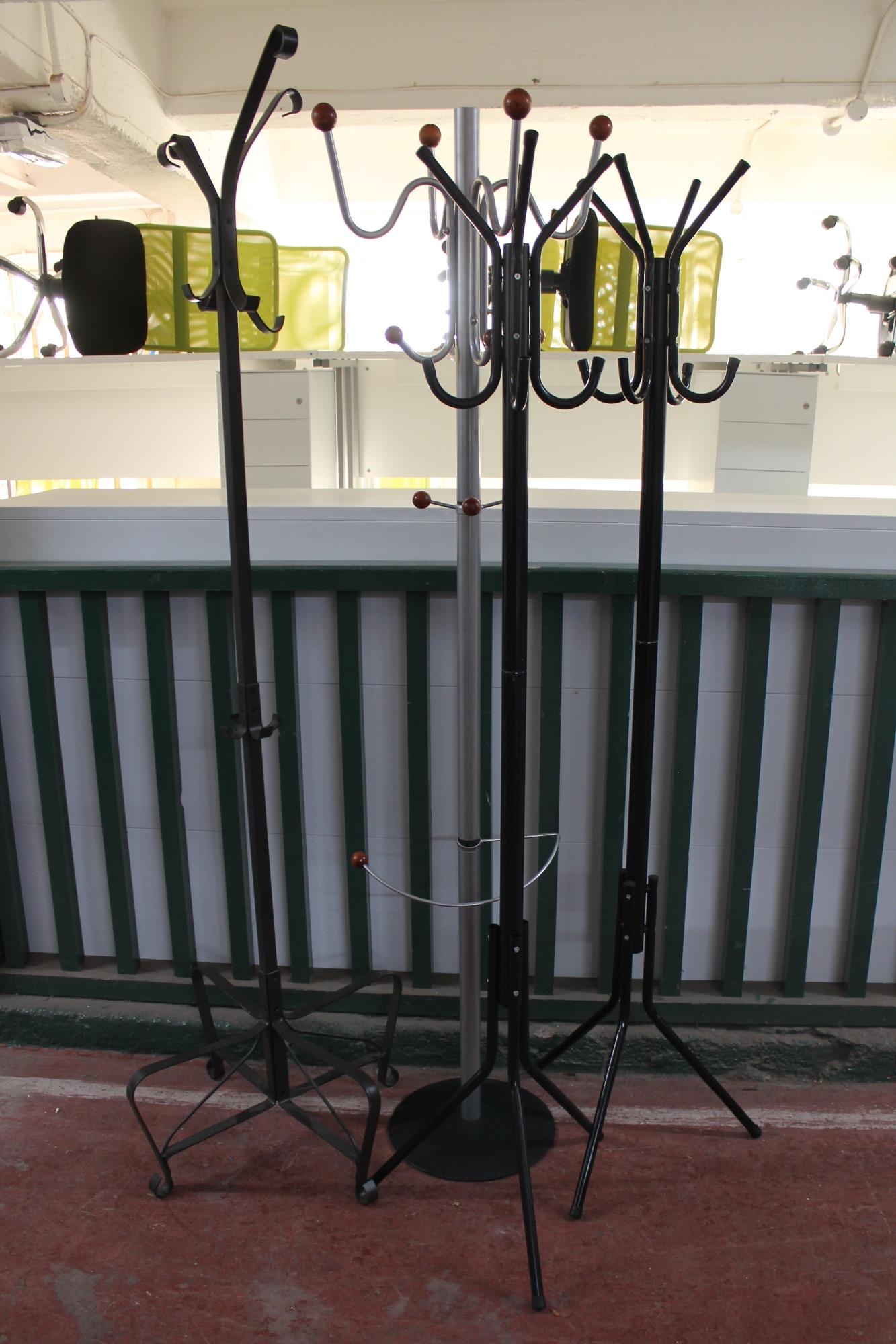 Four metal hat and coat stands