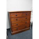 An Edwardian walnut five drawer chest