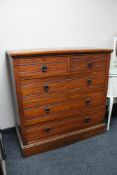 An Edwardian walnut five drawer chest
