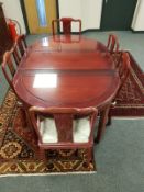 A Chinese hardwood extending dining table (fully extended 160 cm) and six chairs.