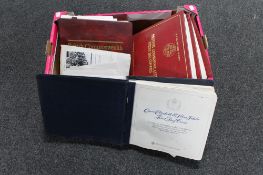 A box of four albums of first day covers,