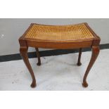 A mahogany bergere seated dressing table stool