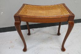 A mahogany bergere seated dressing table stool