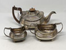 A Georgian silver three piece tea set comprising teapot, milk jug and sugar bowl, maker WB,