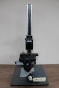 A Metam PB 21 microscope on adjustable stand together with power supply unit