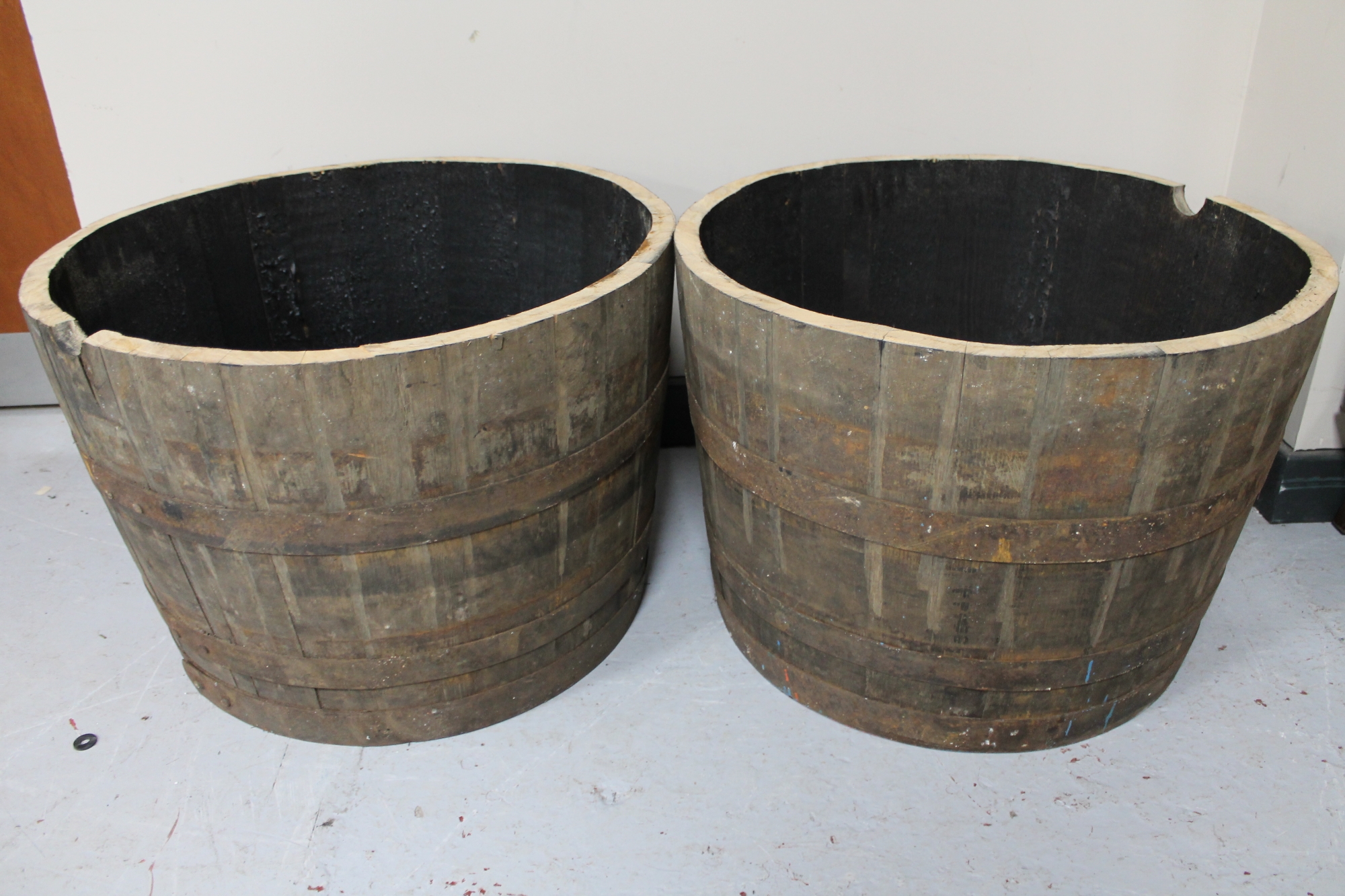 A pair of oak coopered whisky barrel planters