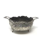 An ornate early 19th century twin handled silver bowl depicting a country scene CONDITION