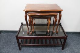 A nest of three Italianate style tables together with a two tier glass topped coffee table