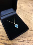 A 10ct yellow gold diamond and topaz pendant on chain