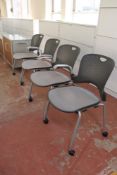 Four office armchairs on castors with mesh fabric seats