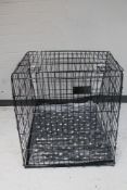 A folding metal dog cage