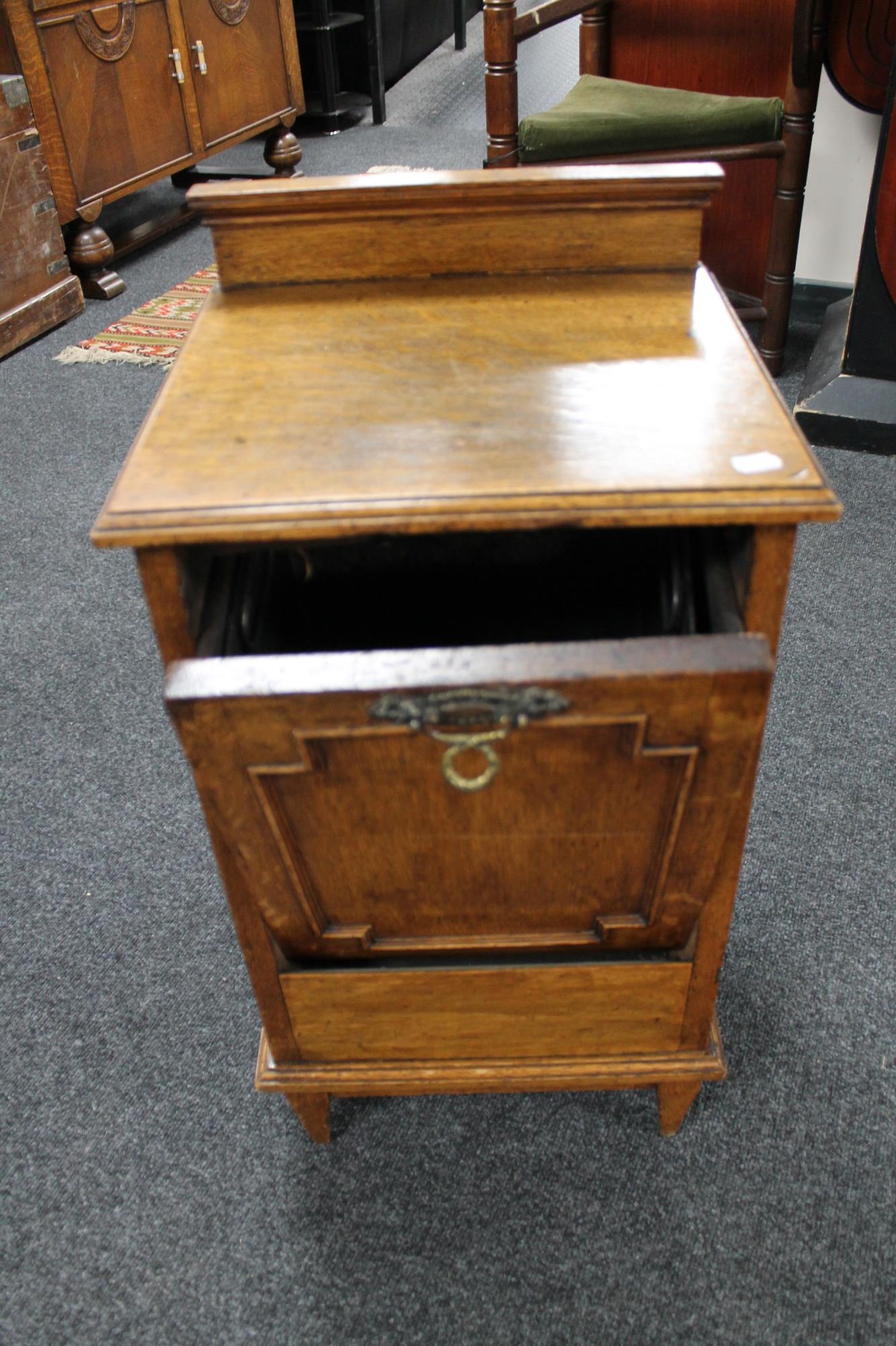 An Edwardian oak coal receiver with liner