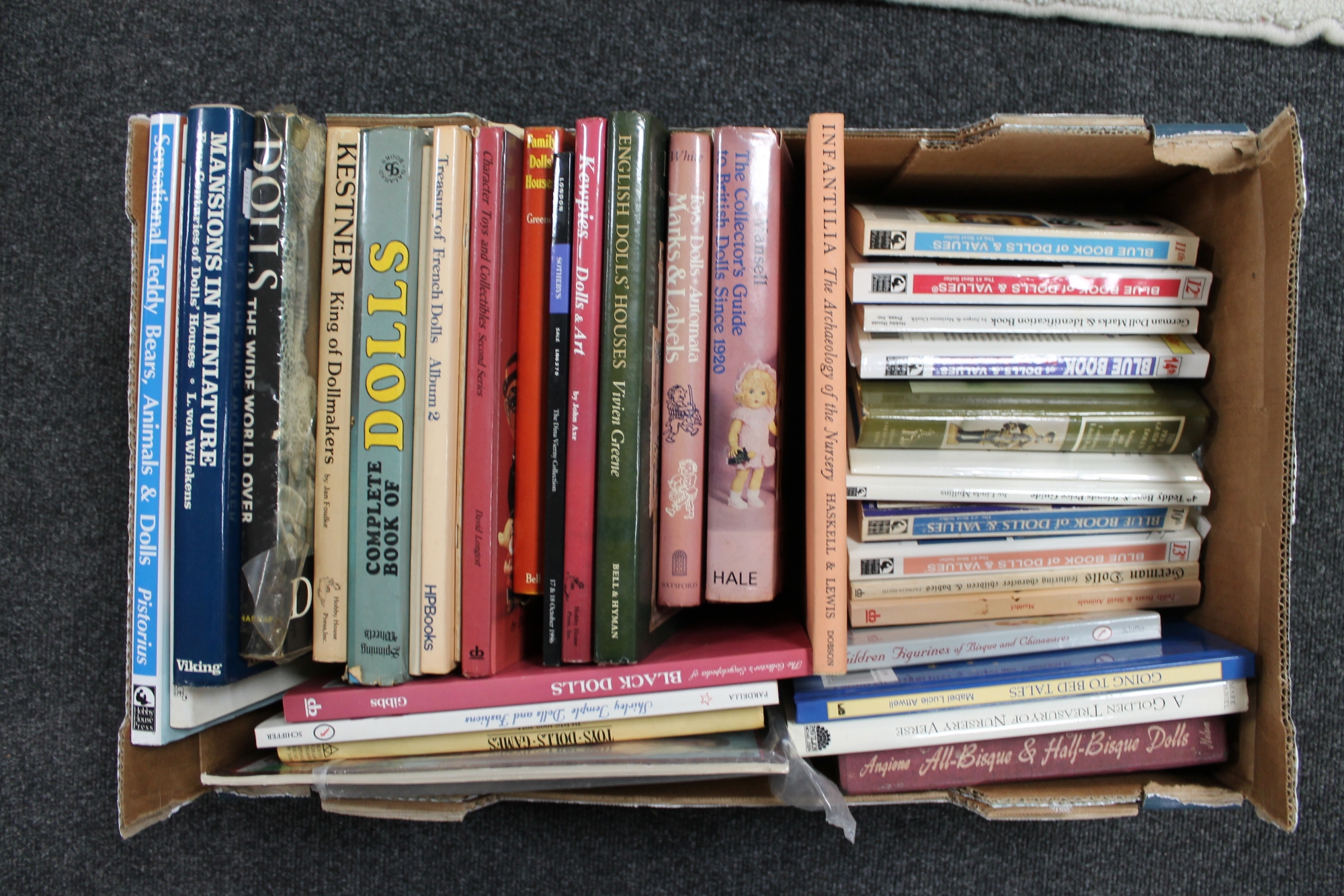 A box of 20th century books relating to dolls,