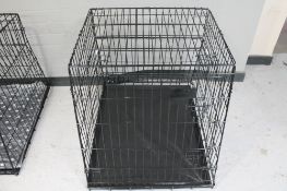 A folding metal dog cage