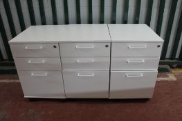 Three white three drawer under-desk filing chests