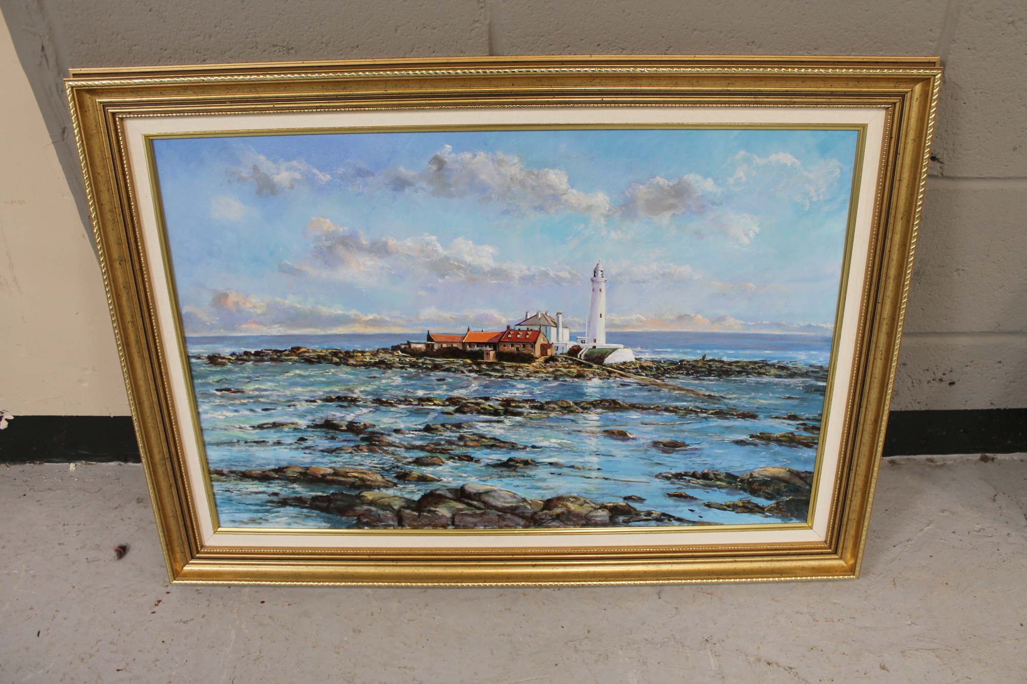 A gilt framed oil on canvas of St Mary's Island by Ray Smith