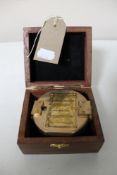 A brass cased natural sine compass in fitted box